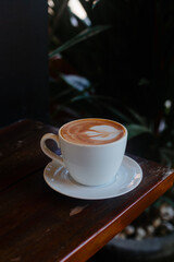Delicious coffee with milk side view. Cappuccino on a dark background