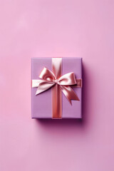 Purple gift box with pink ribbon and bow on pink background.