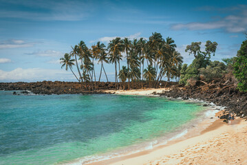 Mahaiula beach with palm trees and lava rocks