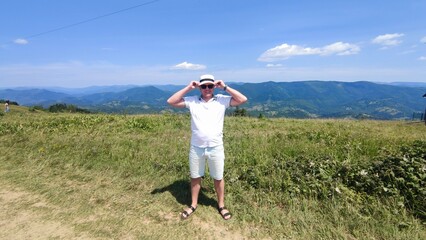 young man on the background of mountains in summer. Carpathians Ukraine