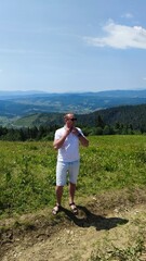 Fototapeta premium Hiker Traveler Relaxing Meditation Mountain View and Landscape Travel Camping Lifestyle Concept Summer Vacation