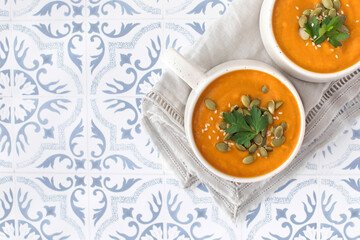 Mugs of warm pumpkin soup. The concept of the autumn menu. Autumn recipes. Copy space