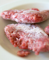 freshly taken out of the deep freezer frozen ground beef, frozen meat,