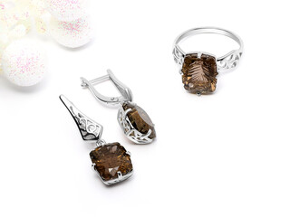 Elegant jewelry set. Jewellery set with gemstones. Jewelry accessories collage. Product still life concept. Ring, necklace and earrings.