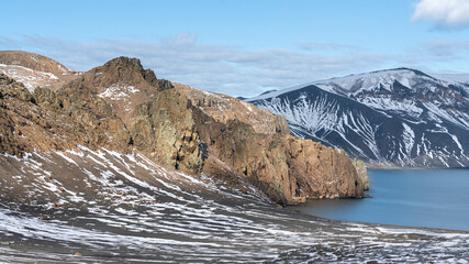 Rugged mountains with a dusting of snow at Deception Island, Antarctica