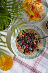 Healthy vitamin-rich balanced vegan breakfast. Raw flaxseed porridge with walnuts, berries, rosehip tea, scrambled eggs with vegetables. Useful homemade veggie lunch. Vitamins, minerals. Gluten free.