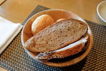 Slices of bread served in a basket on the table