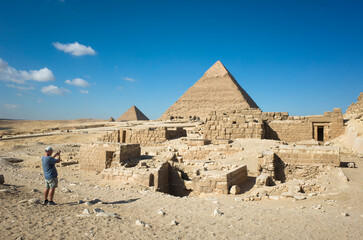 At the Giza pyramid complex a tourist is photographing the pyramid of Khafre, the pyramid of...