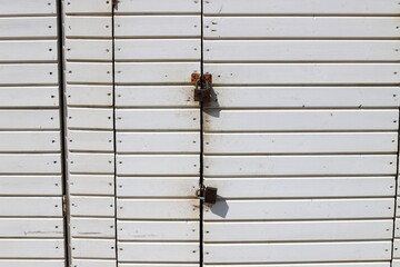 An old padlock hangs on the gate.