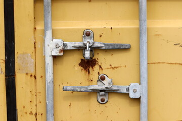 An old padlock hangs on the gate.