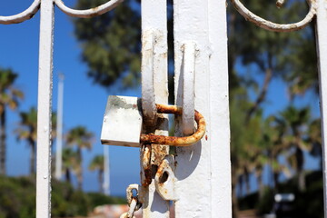 An old padlock hangs on the gate.