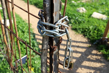Fototapeta na wymiar An old padlock hangs on the gate.