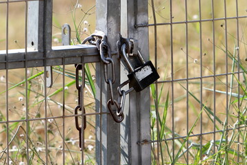 An old padlock hangs on the gate.