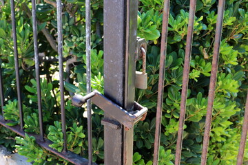 An old padlock hangs on the gate.