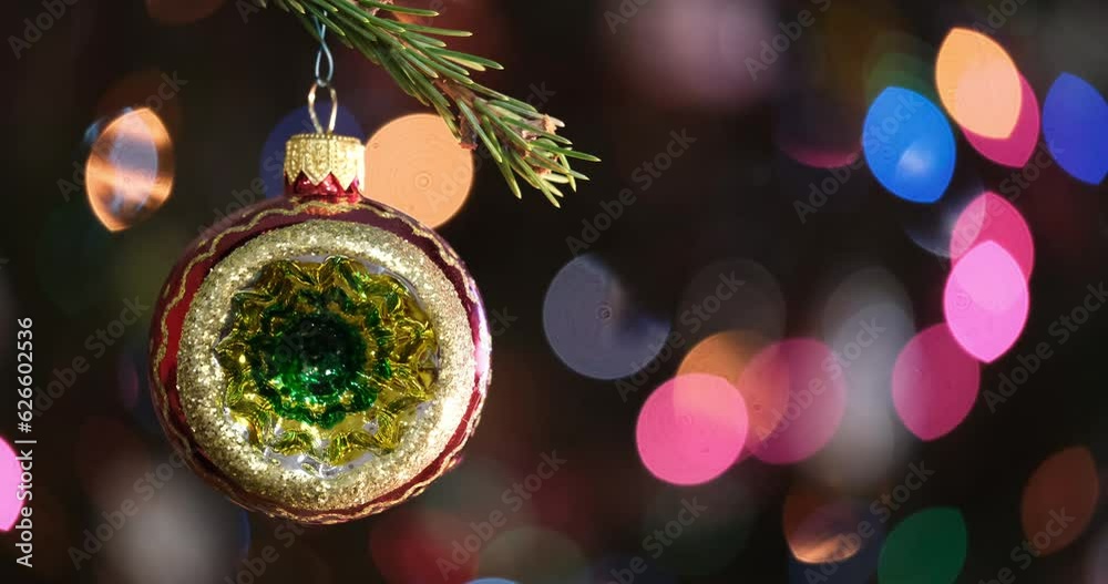 Aufkleber christmas tree decorated red ball toy, fir branch with balls and festive lights on the christmas bac