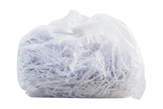 Shredding paper in white garbage bag