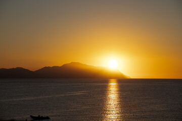 Golden bronze sunset mountain horizon view from the sea ocean natural background desert vacation