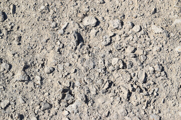 Asphalt road surface. Background texture of gray dry soil with copy space. 