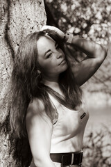 Portrait of a girl near a tree in a city park