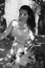 Portrait of a girl by the river in a city park in summer