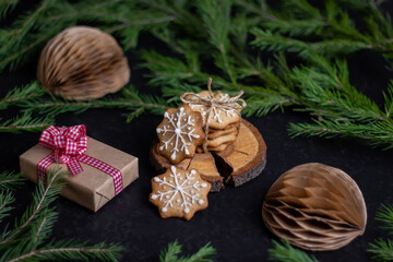 Naklejka na ściany i meble Christmas card with homemade ginger cookies and a fir branch. Christmas background. Festive baking culinary ingredients. Christmas food