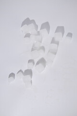Ice cubes are scattered on a white background. Top view, flat lay
