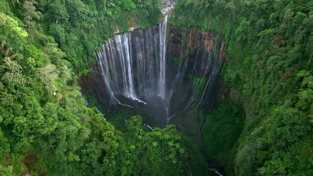 Aerial view from drone of Tumpak Sewu waterfall, falls flow into steep canyon, Malang, East Java, Indonesia
