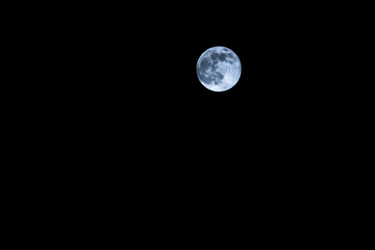 Full moon in front of clear dark sky over hamburg, germany, 2023,  horizontal format