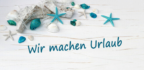 Schriftzug wir machen Urlaub mit maritimer Dekoration. © Racamani