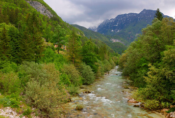 Majestic turquoise Soca river in the green forest, Bovec, Slovenia, Europe. Beautiful rafting and kayaking place in Europe. Great recreation place and kayaking destination.	