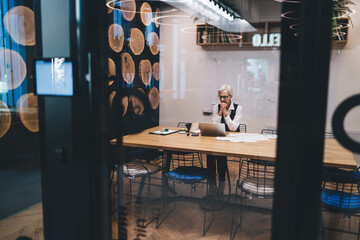 Focused woman working on computer in office