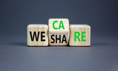 We share and care symbol. Concept word we share we care on wooden block. Beautiful grey table grey background. Business we share and care sharing is caring concept. Copy space.