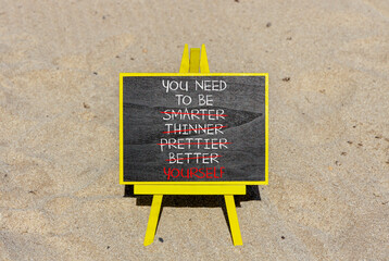 Be yourself symbol. Concept words You need to be yourself, not smarter, thinner, prettier, better on black chalk blackboard on beautiful sand background. Psychological be yourself concept. Copy space