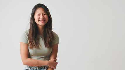 Young woman smiling looking at camera and smiling, isolated on white background, studio shot