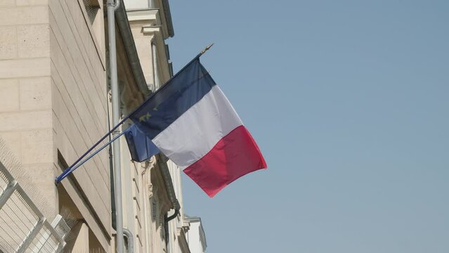 french flag hanging on Hotel De Ville town hall in Paris