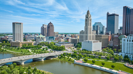 Fototapeta premium Aerial Columbus Ohio with bright blue sky with clouds and bridge over Scioto river