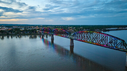 Silver blue sunset over arch bridge aerial rainbow pride illuminated at night over Ohio River