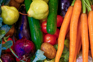 Various fresh ingredients for cooking such as potato, carrot, tomato and cucumber.