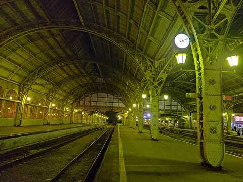 Night view of empty platform of the Vitebsk railway station. Architecture of old Russian railway terminal with a metal arched sroof.  St. Petersburg, Russia. September 18, 2022