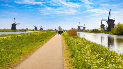 A great panorama that shows a central path, where tourists walk, on each side of the canals, on the...