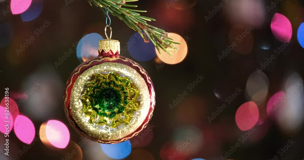 Aufkleber christmas tree decorated red ball toy, fir branch with balls and festive lights on the christmas bac