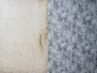 One room has been partially renovated. copy space. Pasting paper wallpaper on concrete walls.