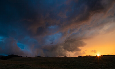 Obraz na płótnie Canvas Landscape with sunset and dark storm clouds