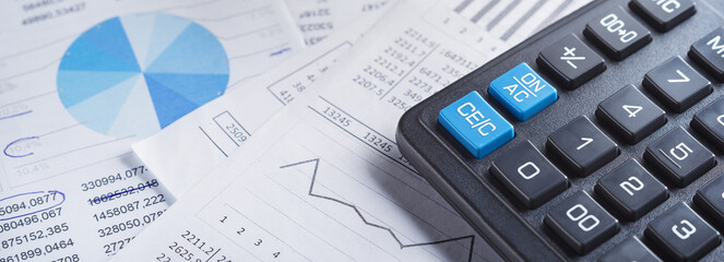 calculator and financial charts. Investment and capital accumulation concept