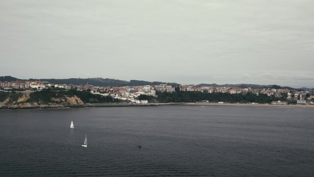 Luxury yachts and leisure boats near the Bilbao, Spain harbour, situated by the Playa de Ereaga beach, adjacent to the Getxo and Neguri neighborhoods.