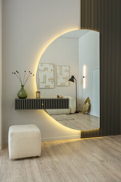 bright open-plan apartment in a modern design, light walls and wooden floor in a room with daylight