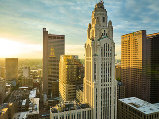 Golden sunrise striking main office building skyscrapers in aerial of Columbus city Ohio