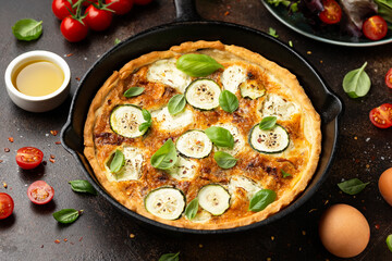 Sun baked tomato, goats cheese and courgette quiche served in cast iron pan with side salad
