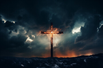 Low angle view of a glowing cross against a dark dramatic sky