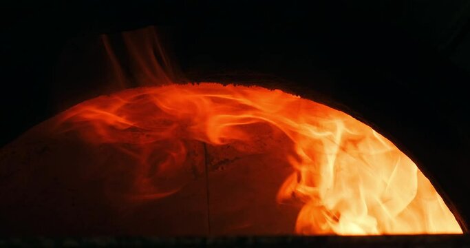 Closeup shot of flames in the oven. Slow motion burning bonfire. Burning firewood in stove oven